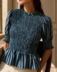 Blouse péplum smockée à col volanté