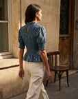 Blouse péplum smockée à col volanté