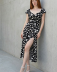 Robe longue noire à imprimé floral fendue côté élégante