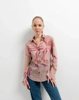 Portrait d'une femme en chemise fleurie femme semi-transparente, ajoutant une touche de sophistication à sa tenue.