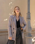 Modèle en action avec le blazer femme double boutonnage à carreaux de Sapiato, arborant une ambiance chic et moderne.
