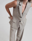 Détail d'un gilet sans manches femme chic à rayures fines élégant, avec boutons contrastés, mettant en valeur un style tailleur moderne. Gilet costume femme parfait pour toutes occasions.