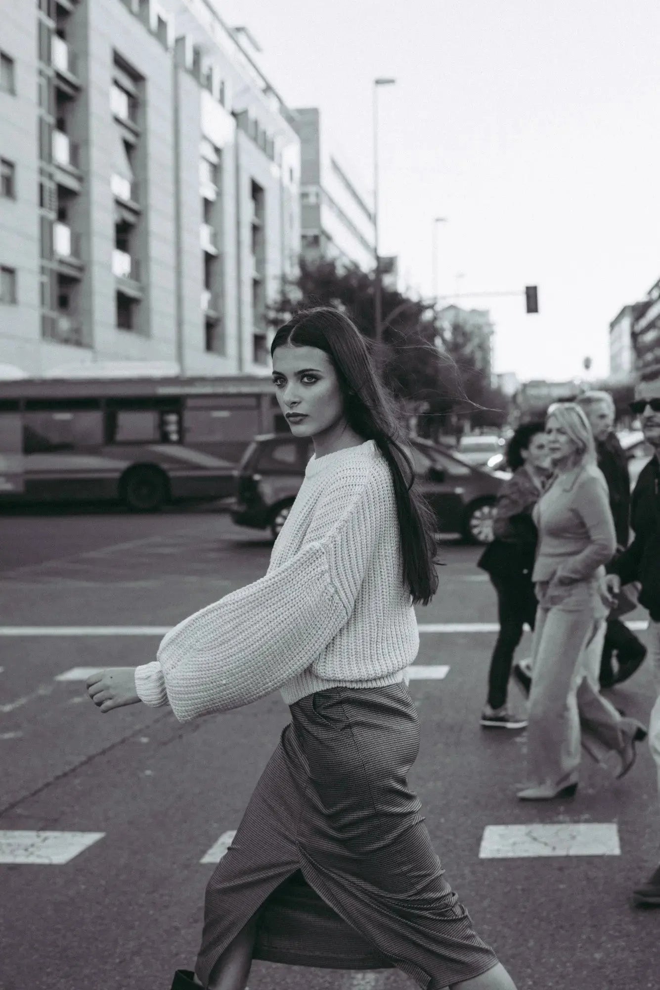 Femme portant un pull crème en tricot surdimensionné à manches ballon et une jupe foncée