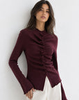 Pull en maille bordeaux fronces et boutons recouverts