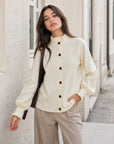 Gilet en maille beige col volanté