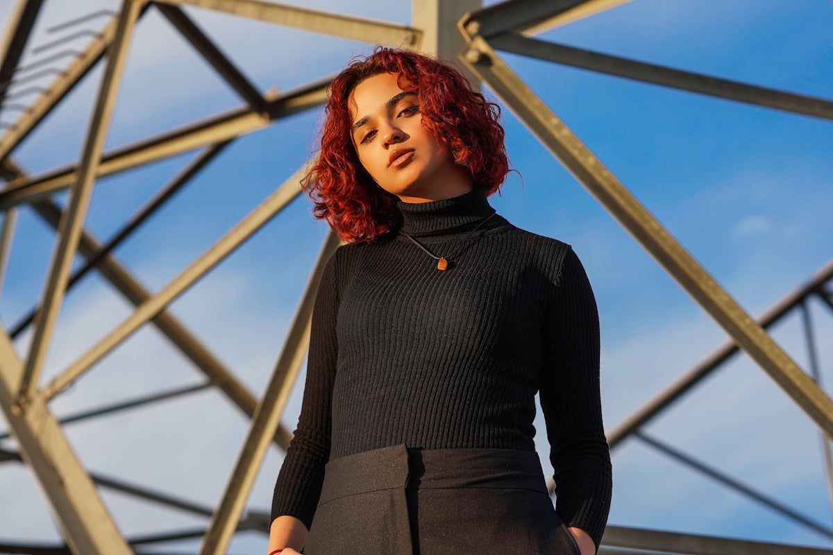 a person standing in front of a metal structure