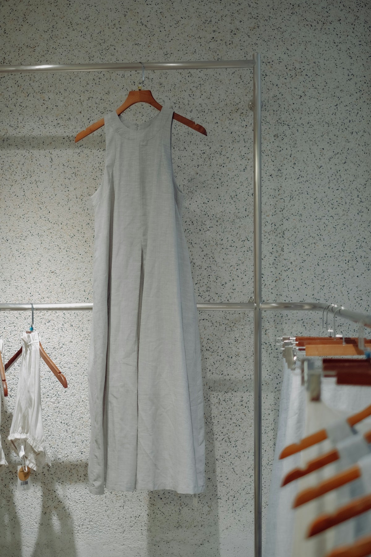 a white dress hanging on a clothes rack