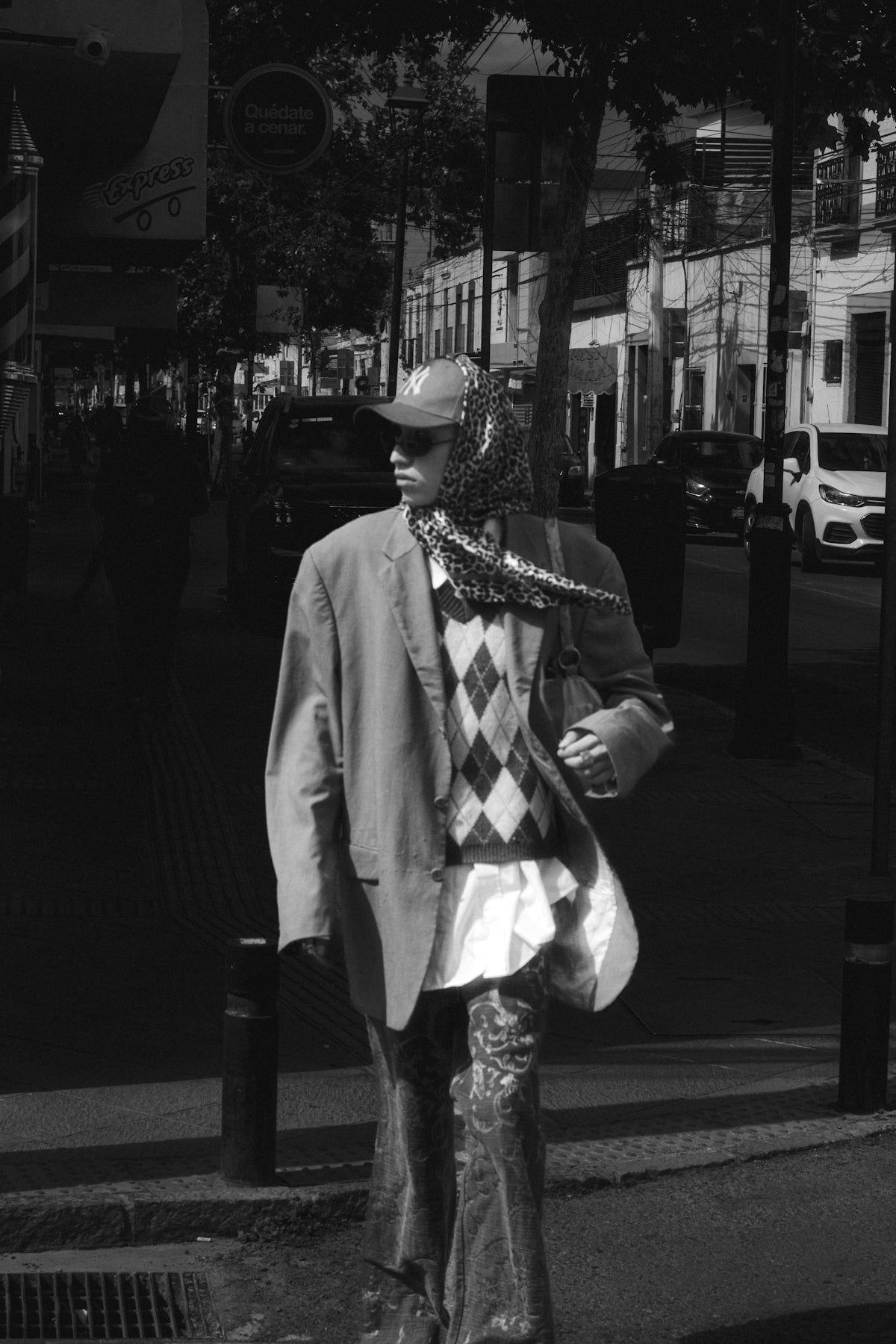 A man in a suit and tie walking down the street