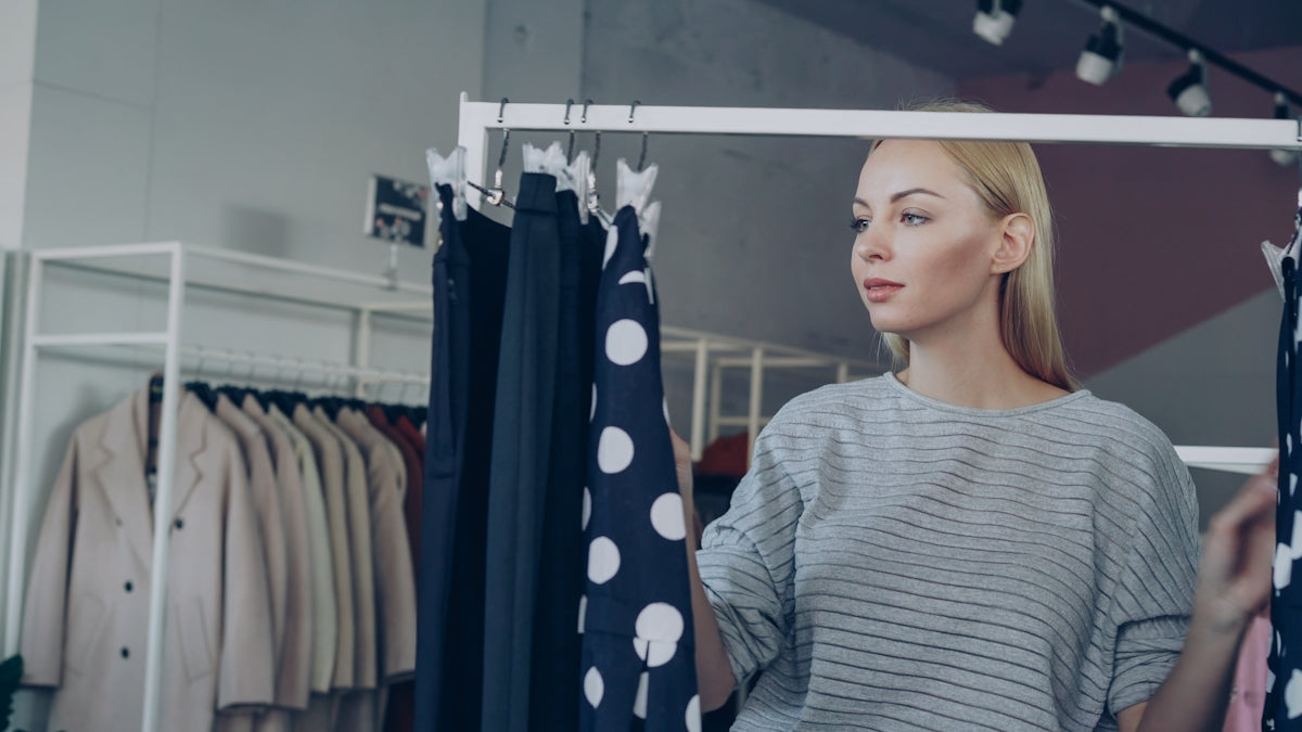 Woman selects clothes in a clothing store.