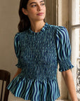 Blouse péplum smockée à col volanté