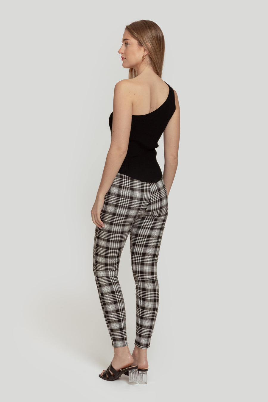 Vue arrière d'une femme dans un pantalon slim imprimé femme noir à taille élastique, mettant en valeur le style ajusté et contemporain.
