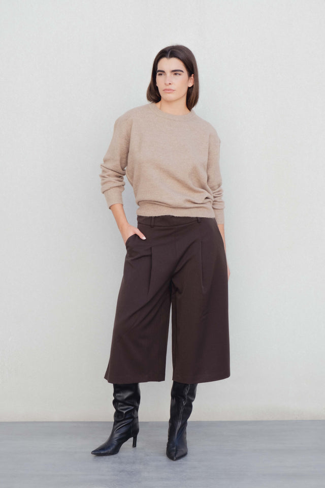 Modèle mettant en valeur le Bermuda long à pinces coupe droite marron coton stretch avec un pull beige, idéal pour un style casual-chic, représentant le bermuda large femme et bermuda femme long.