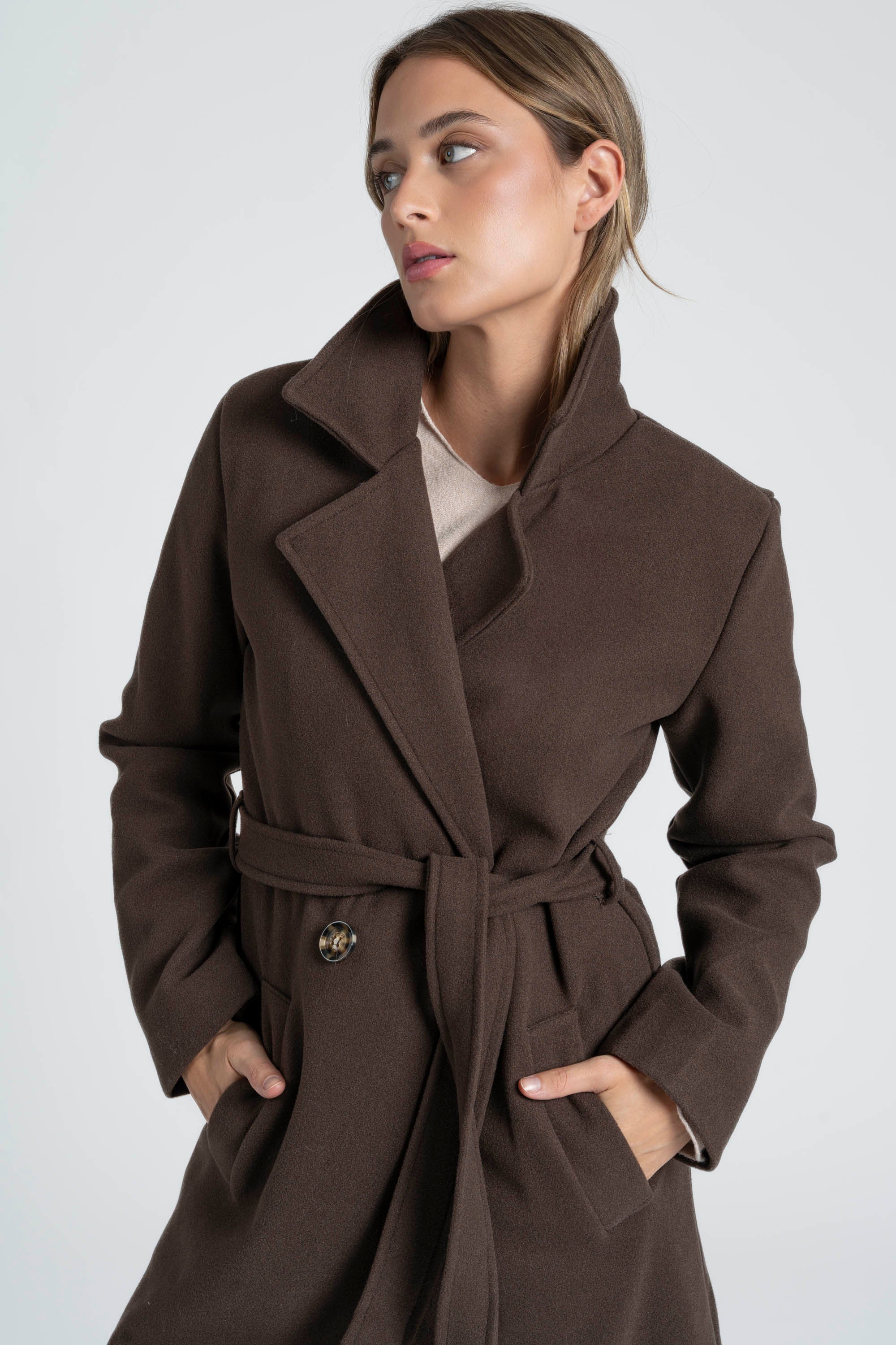 Détail du manteau croisé femme marron, mettant en avant le col structuré et la ceinture à nouer.