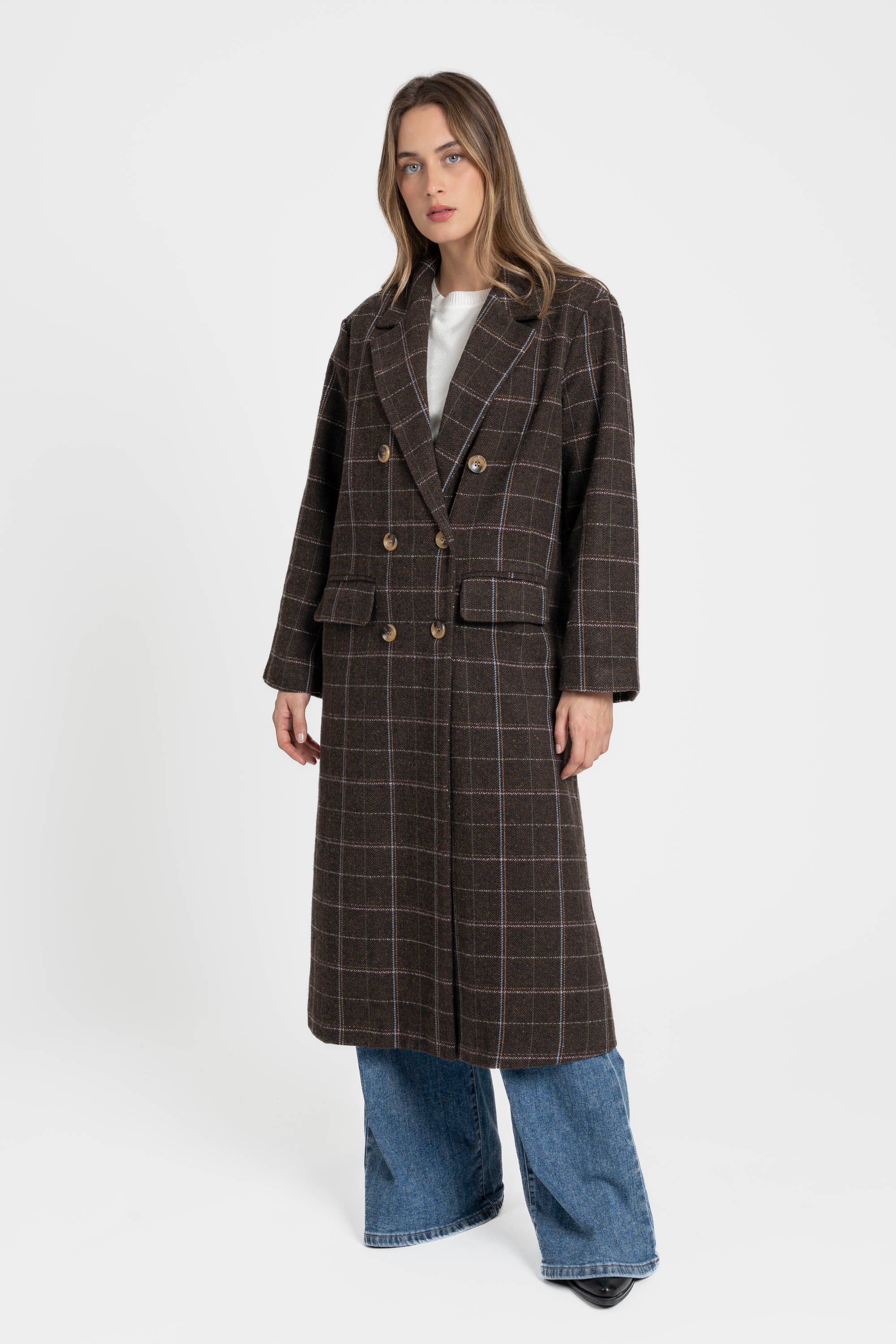 Femme portant un manteau long croisé marron en coton mélangé, présentant une silhouette élégante avec des boutons, parfaite pour le quotidien. Manteau long croisé femme en coton mélangé marron.