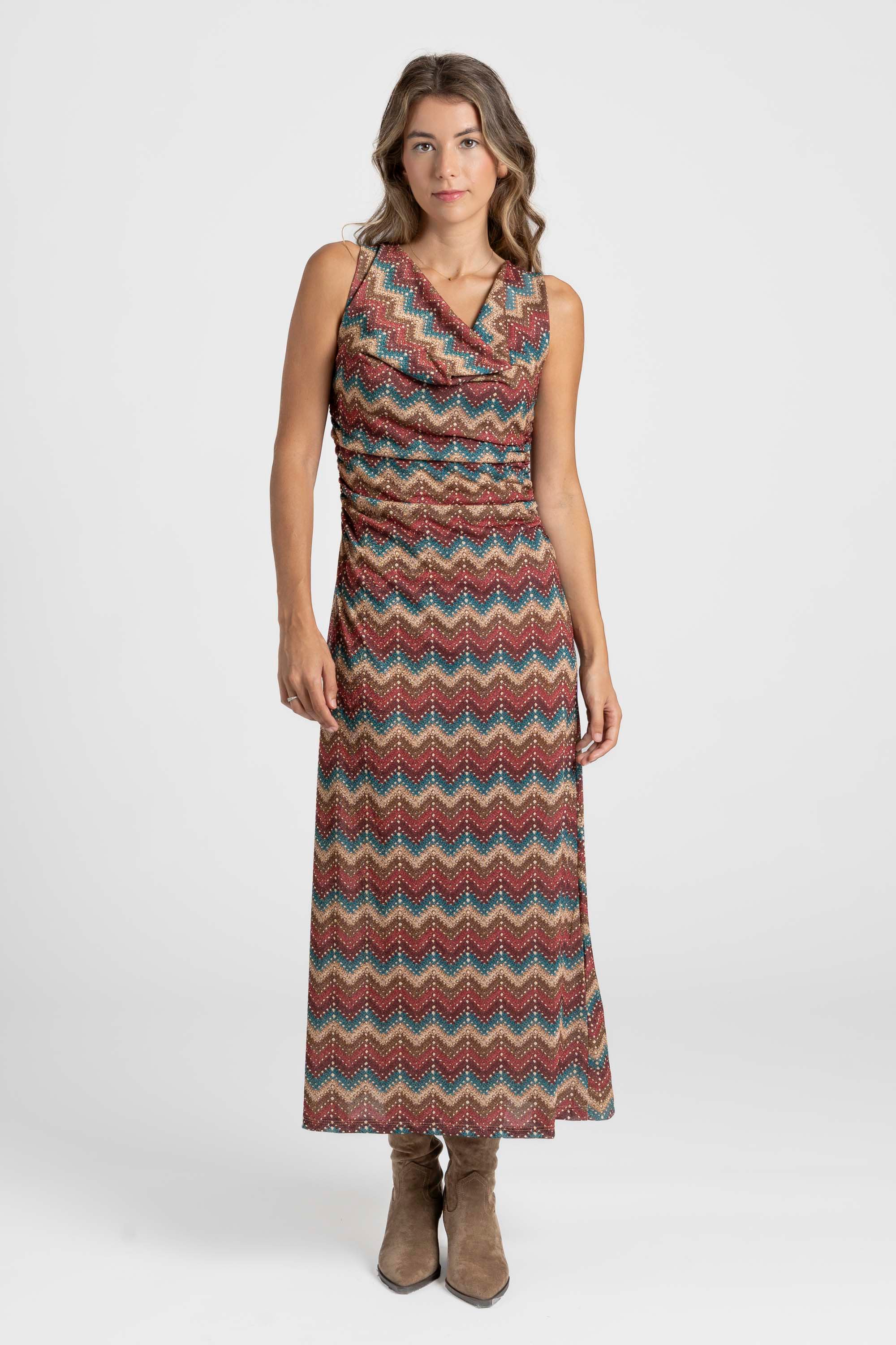 Modèle dans une robe longue fluide colorée, mélange de marron et de rouge, présentant une encolure en V flatteuse.