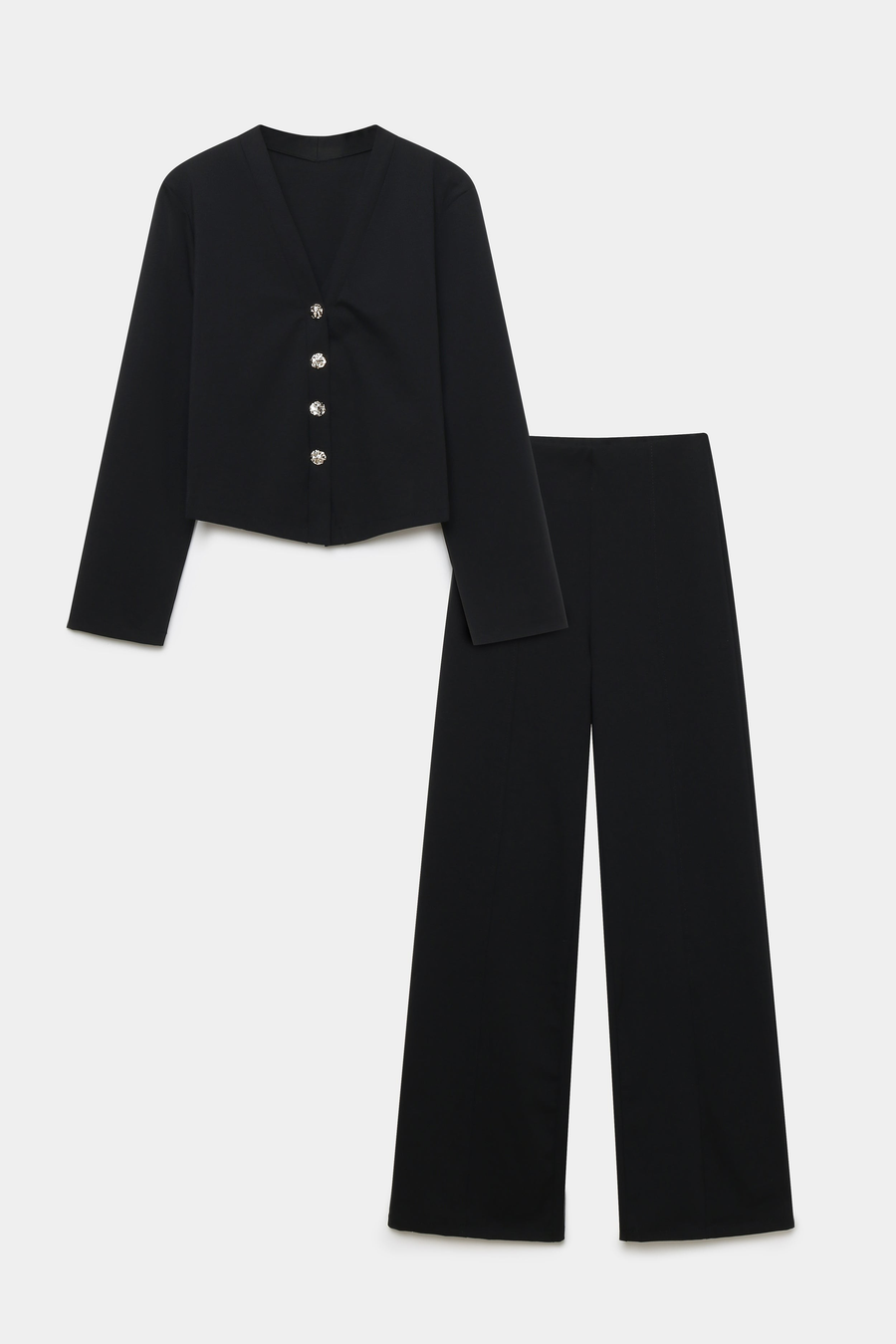 Image de l'ensemble deux pièces coton femme en noir, avec une veste à col V et un pantalon structuré, présenté sur fond blanc.