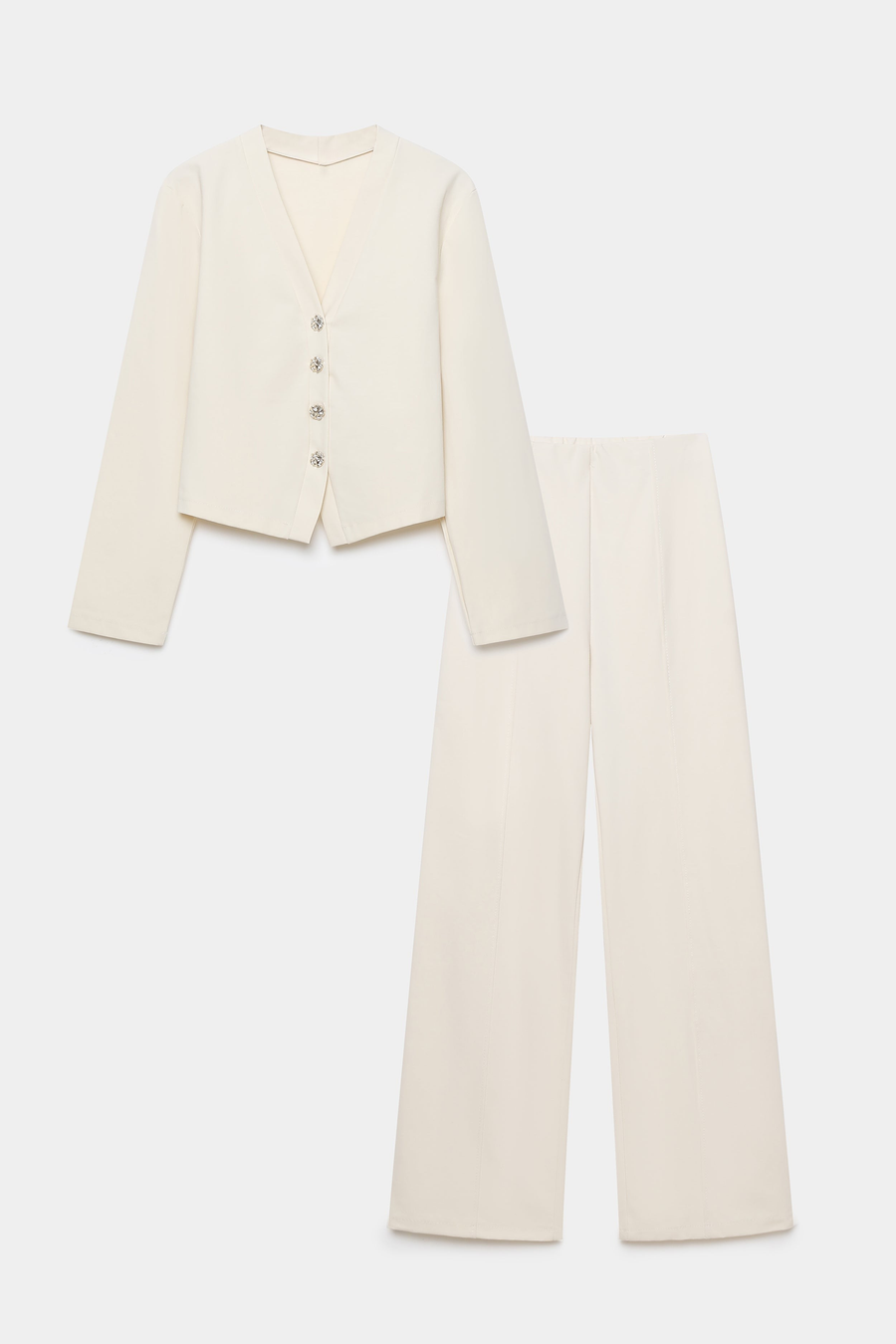 Image de l'ensemble deux pièces coton femme en blanc, comprenant une veste à col V et un pantalon structuré, sur fond blanc.