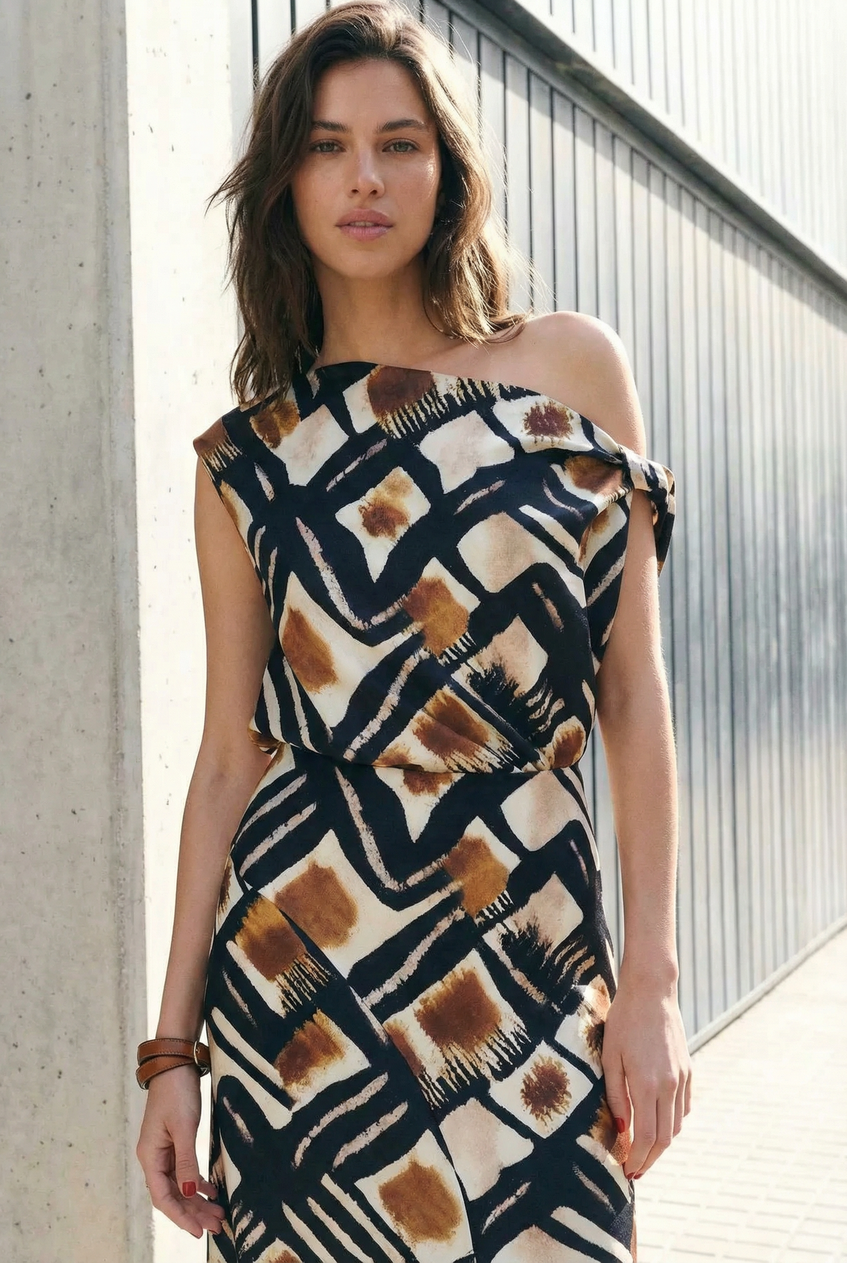 Top asimétrico de un solo hombro para mujer con estampado gráfico en marrón, negro y blanco, elegante y moderno.