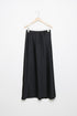 Jupe midi droite satinée noire sur un cintre, montrant la finition soignée en 100% polyester.