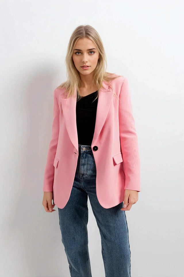 Blazer rose femme au confort inégalé, présenté avec un détail de bouton noir, parfait pour un look chic et sophistiqué.