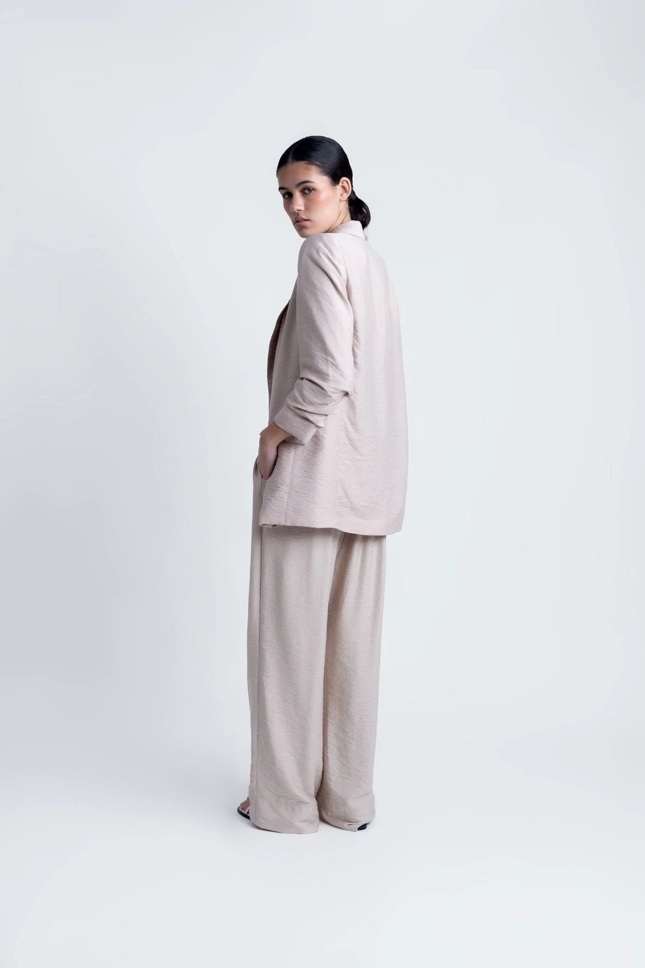 Démonstration de la coupe arrière d'une Veste Légère Femme Beige Texturée Oversize à Épaules Structurées, Style Casual Chic.