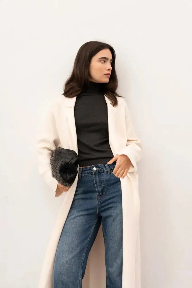 Femme en maille oversize cosy chic portant un cardigan maille oversize et un sac en osier noir