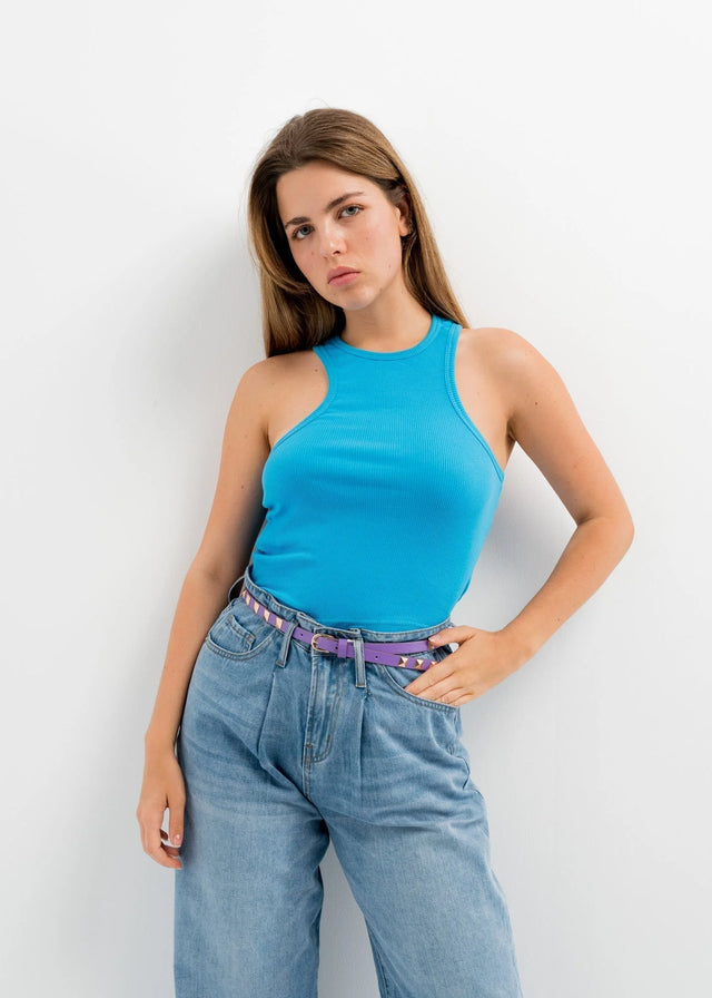 Mode femme avec ceinture noire rock chic à clous dorés, portant une ceinture noire cloutée pour un style décontracté et tendance.