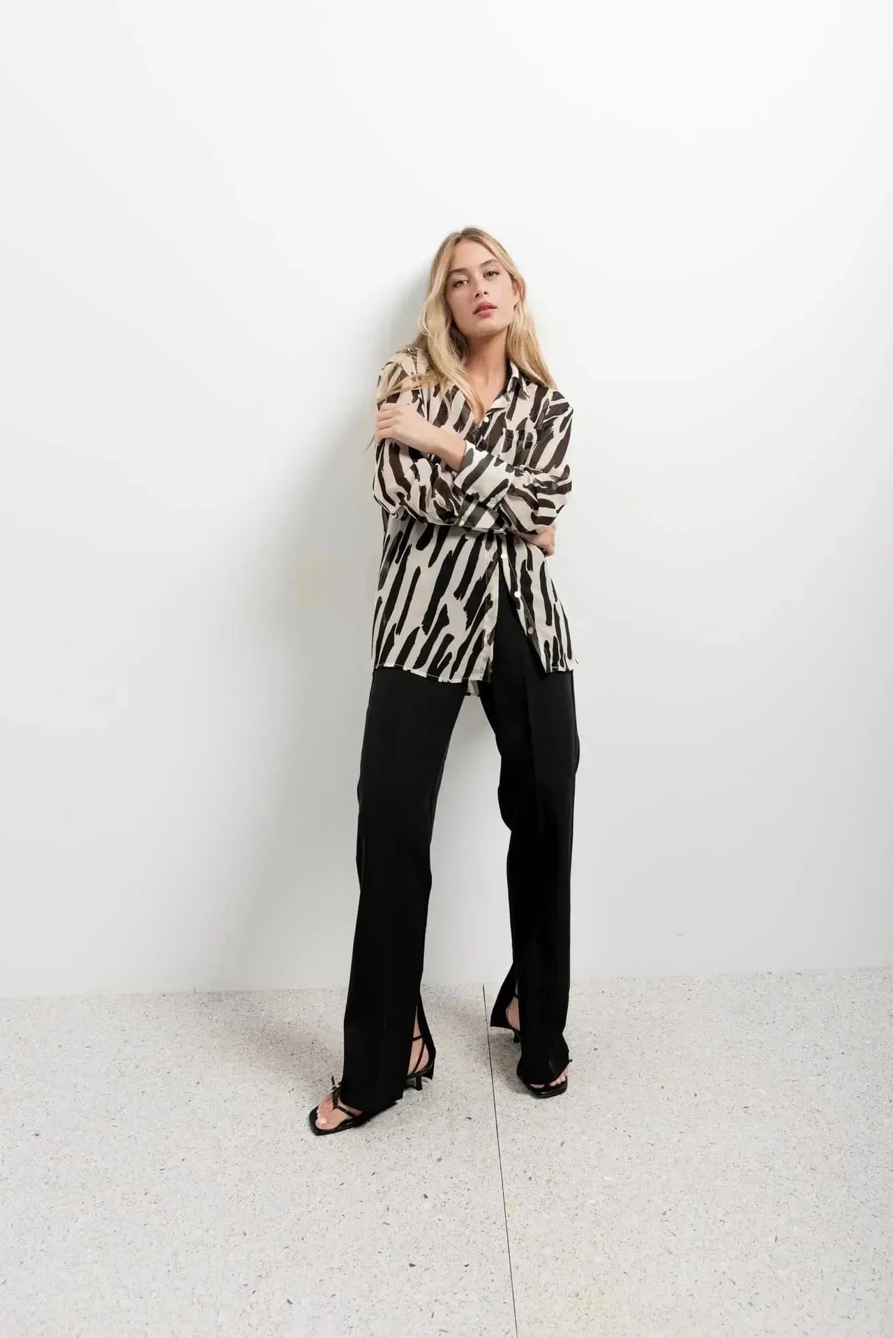 Chemise Transparente Femme Motif Zèbre Noir et Beige, Fluide et Élégante, portée par un modèle en pose décontractée, idéale pour des looks chics.