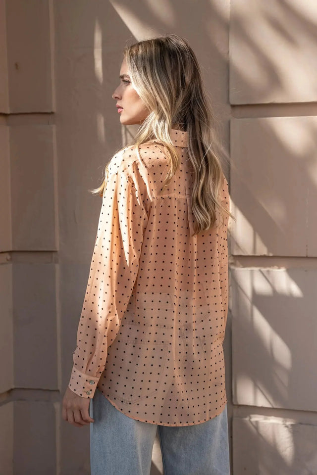 Profil de la Chemise Transparente Femme À Pois Noirs, vue de côté, soulignant la fluidité et le style élégant de cette blouse.