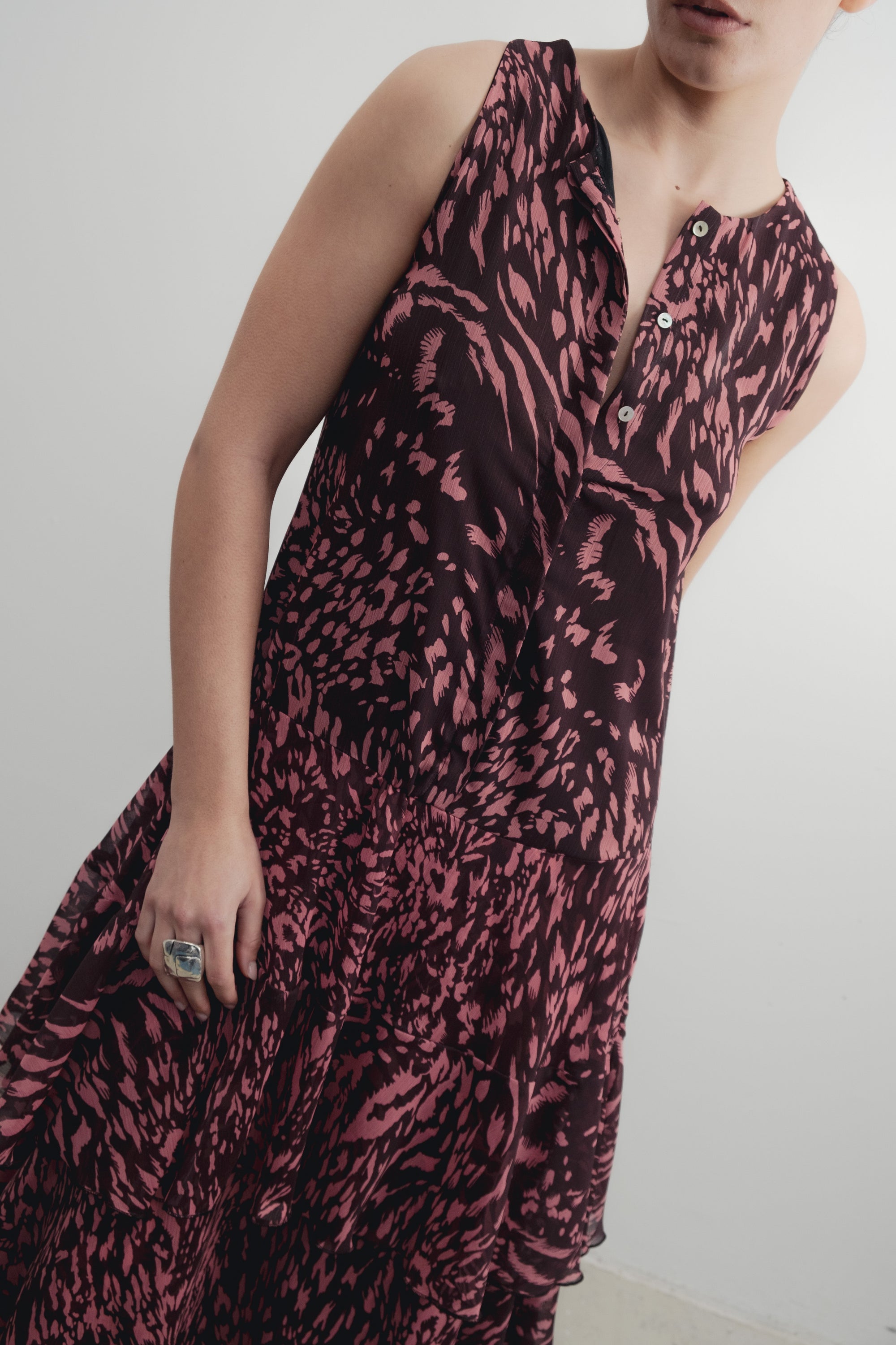 Robe longue imprimée à volants sans manches marron, gros plan sur le décolleté et les détails de la robe.