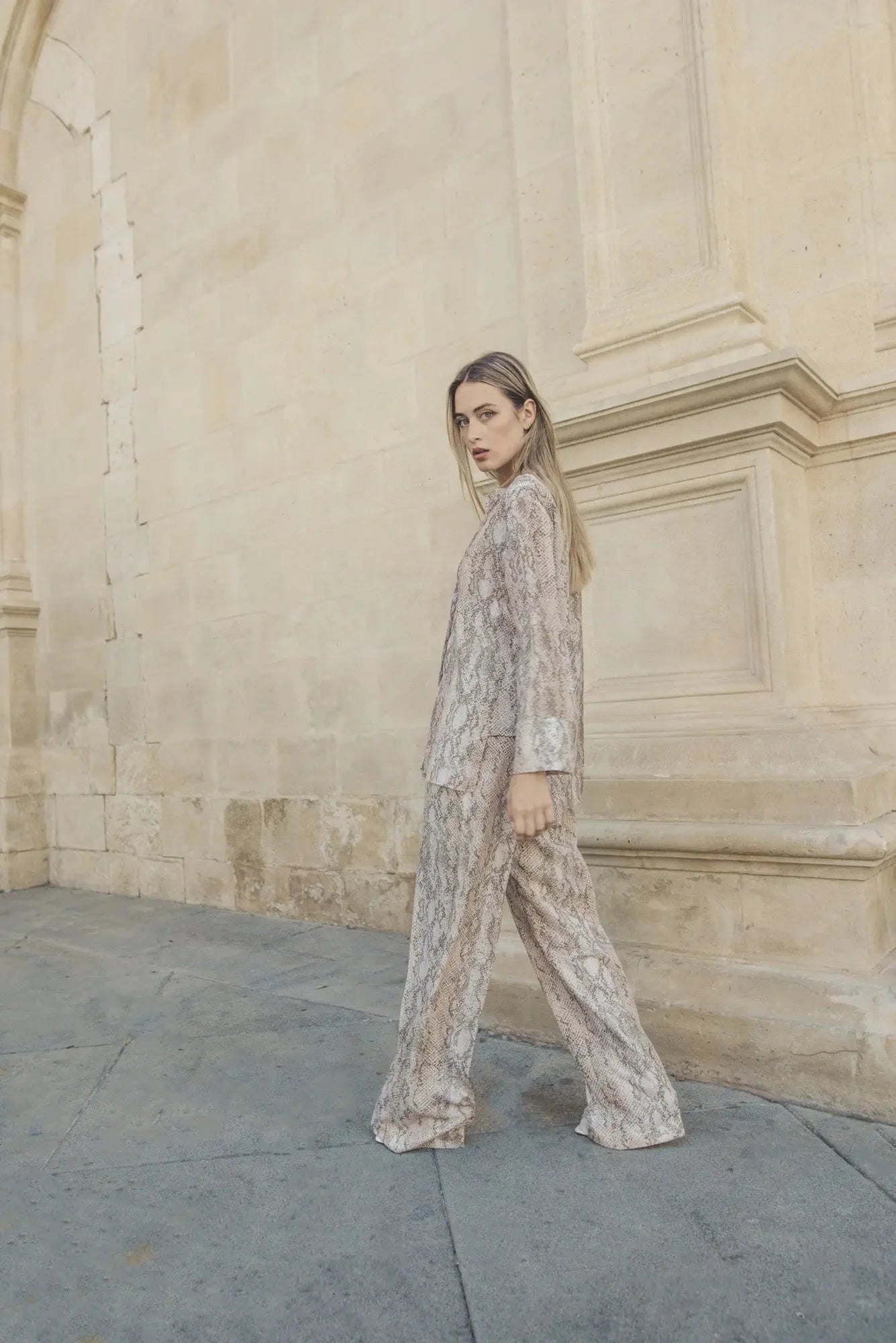 Femme portant une chemise imprimée animal brillante et fluide, mode élégante