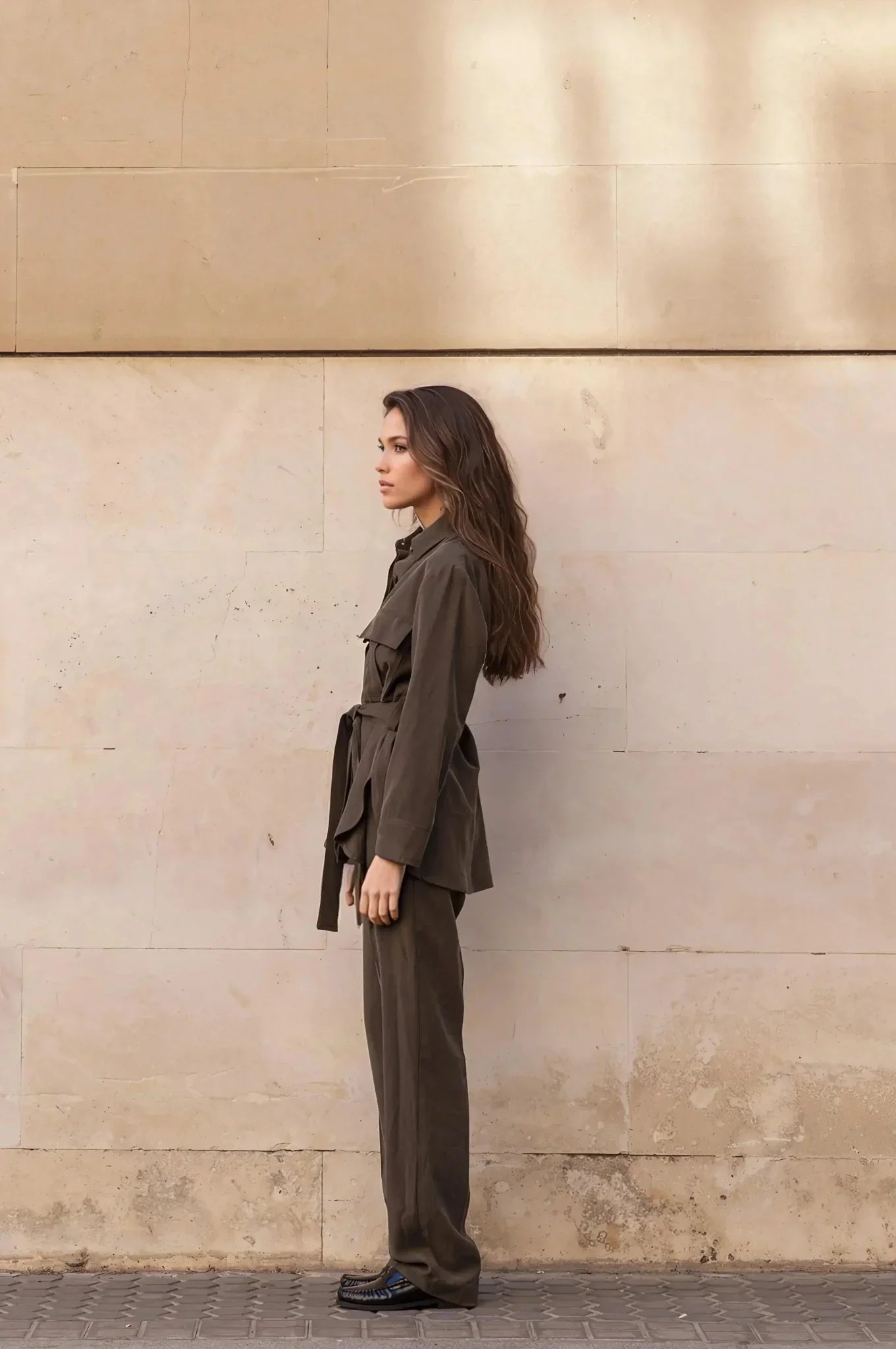 Femme portant un ensemble coordonné chemise et pantalon en vert olive foncé avec ceinture