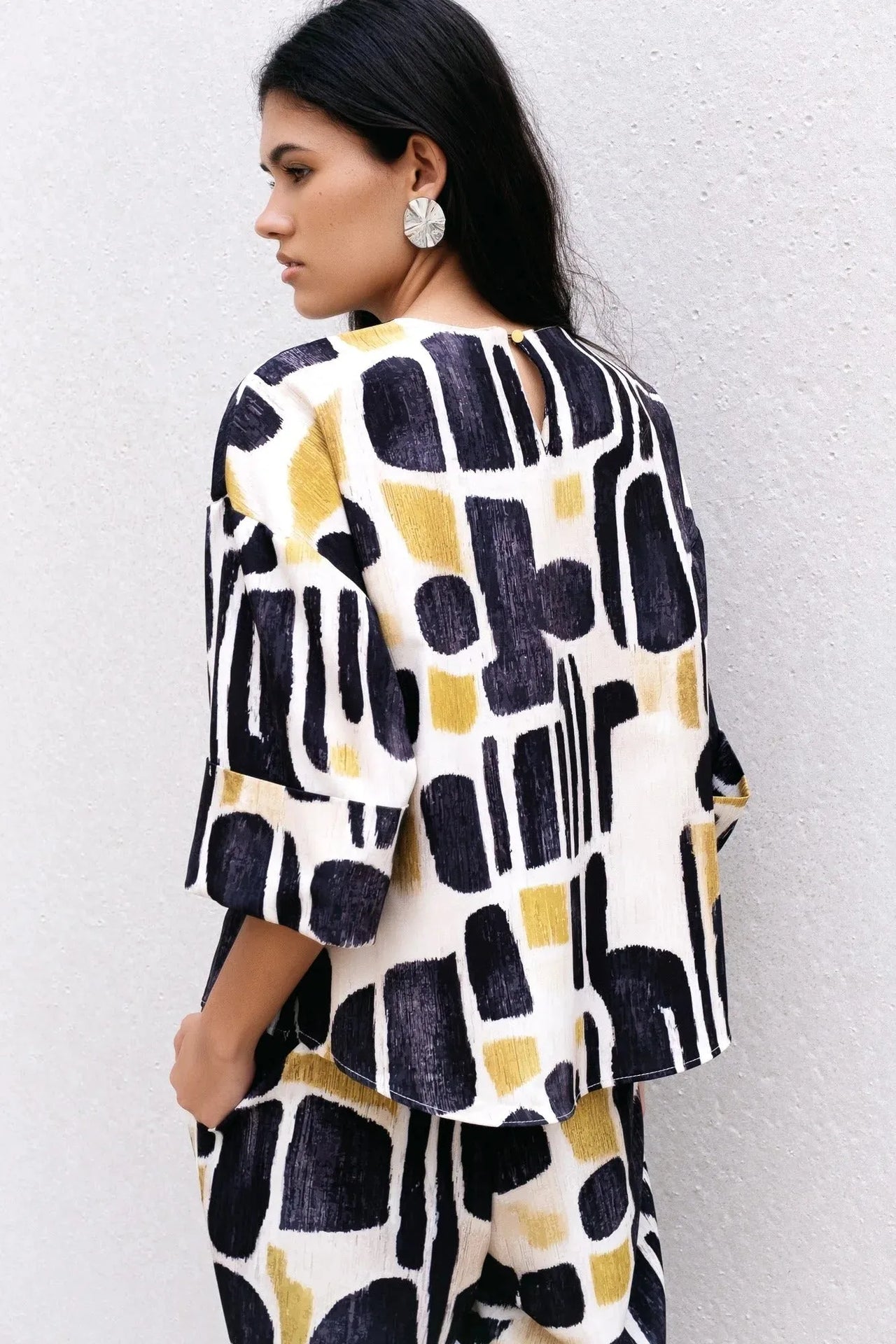 Vue arrière de la Blouse Tendance Femme Sapiato, illustrant le design raffiné et le confort optimal.