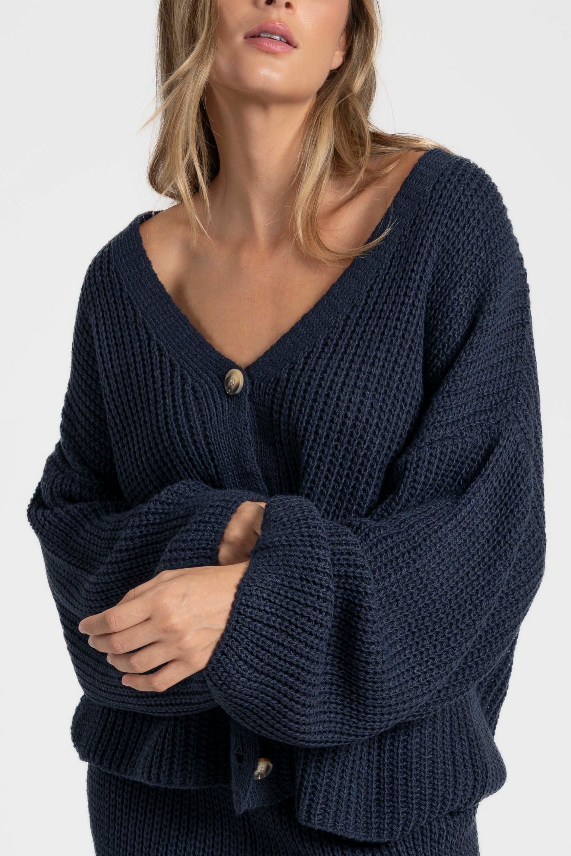 Détail du haut d'ensemble maille femme italien foncé, porté par une femme avec un sourire.