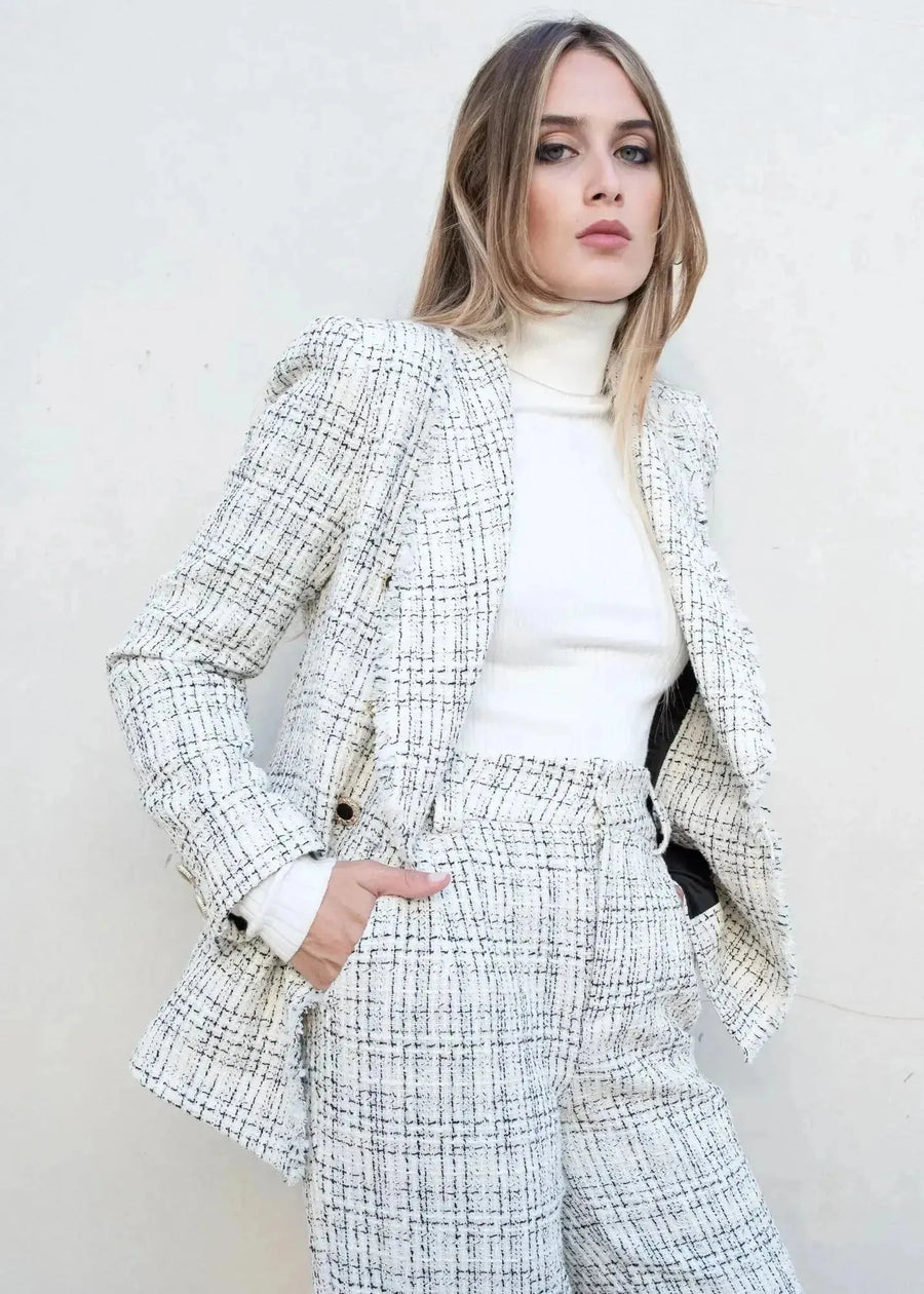Femme portant un blazer et un pull col roulé femme, parfait pour l'hiver, accessible dans les indispensables de la garde-robe d’hiver.