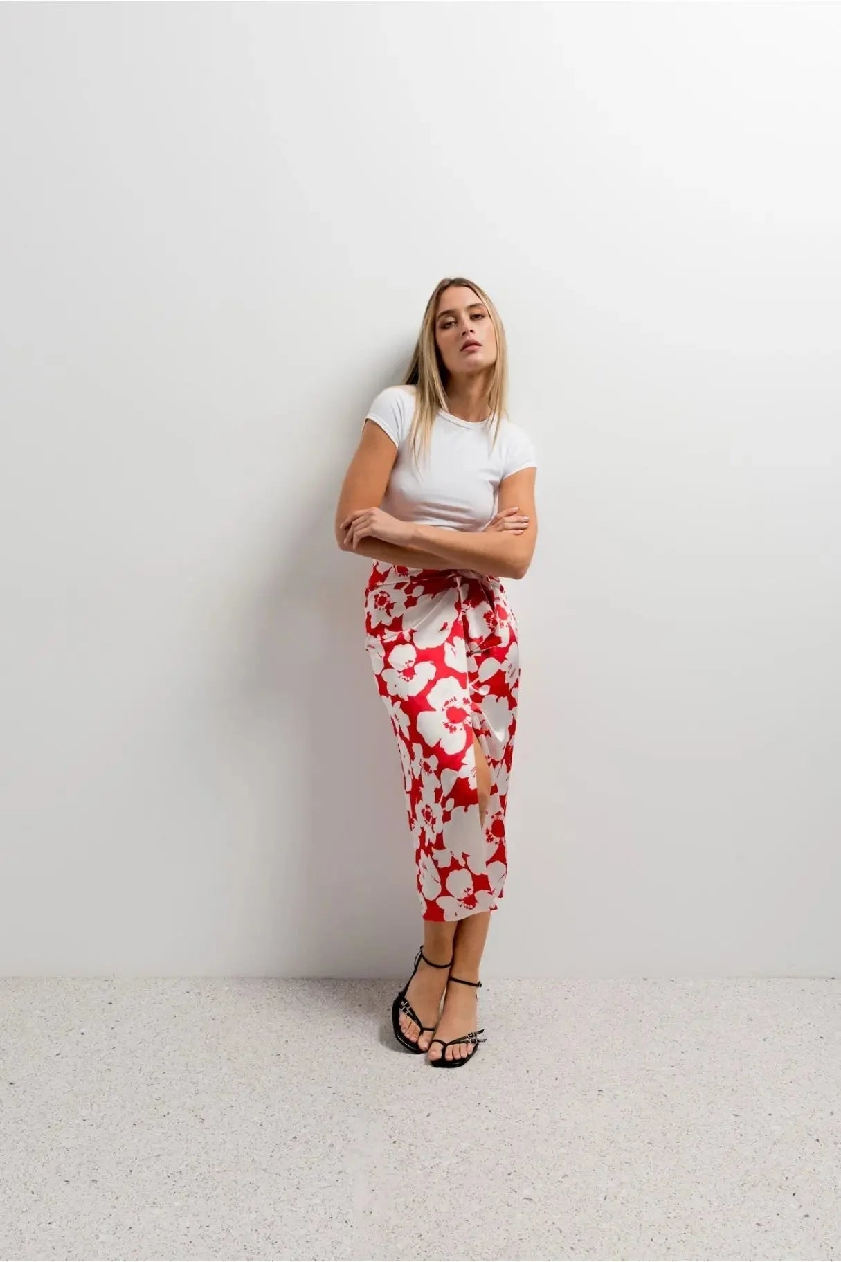 Modèle portant la Jupe Portefeuille Midi Imprimée Florale Avec Nœud par Sapiato, affichant un style chic et élégant, parfaite pour le quotidien avec ses motifs floraux et sa coupe confortable.