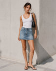 Mini jupe en denim bleu délavé portée vue en pied