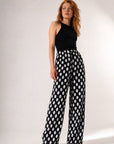 Pantalon palazzo noir à gros pois taille haute