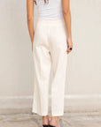 Vue arrière d'une femme en pantalon lin femme taille haute blanc – Chic & Fluide Pour L'Été, mettant en avant le design simple et élégant.