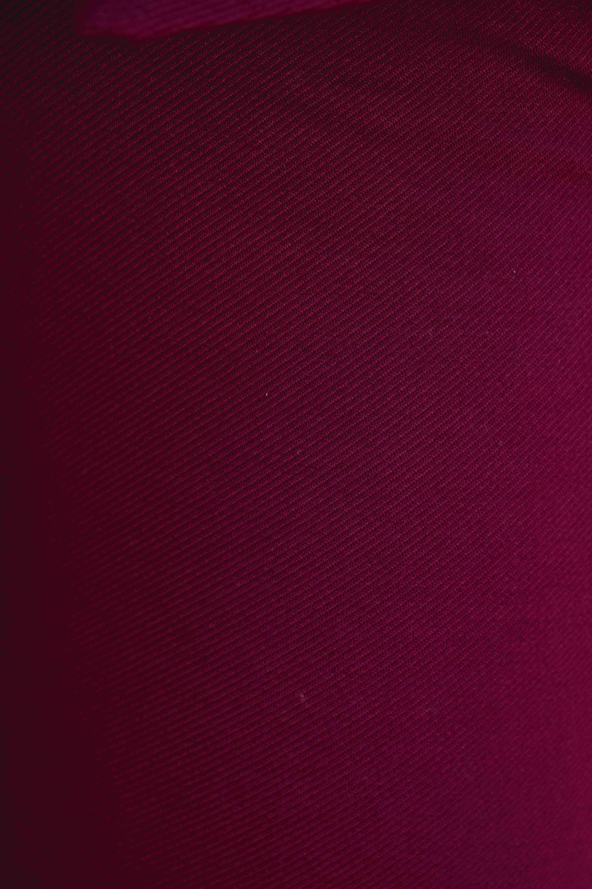 Gros plan sur la texture bordeaux du pantalon en maille texturée taille haute flare viscose, idéal pour mettre en valeur le confort et le style du pantalon maille femme.