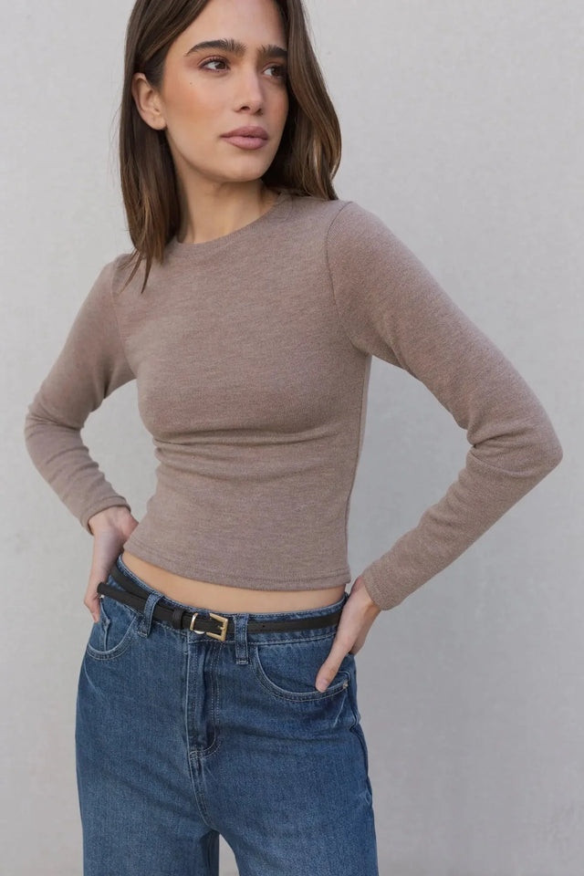 Pull ajusté femme col rond manches longues en polyester et viscose - Noir et Beige, modèle féminin portant un pull beige ajusté avec jeans bleu.