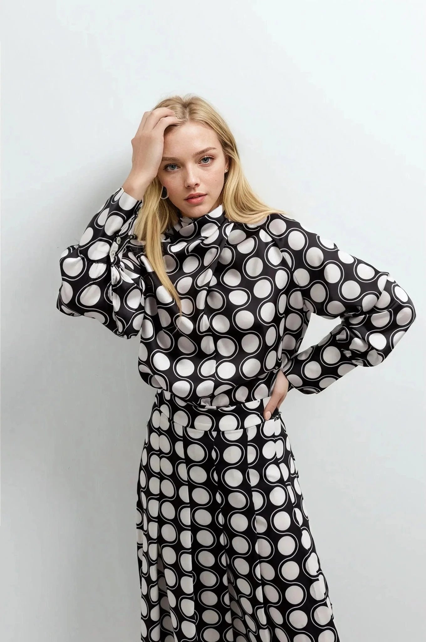 Blouse en satin noir et blanc à pois avec col foulard et jupe midi imprimée