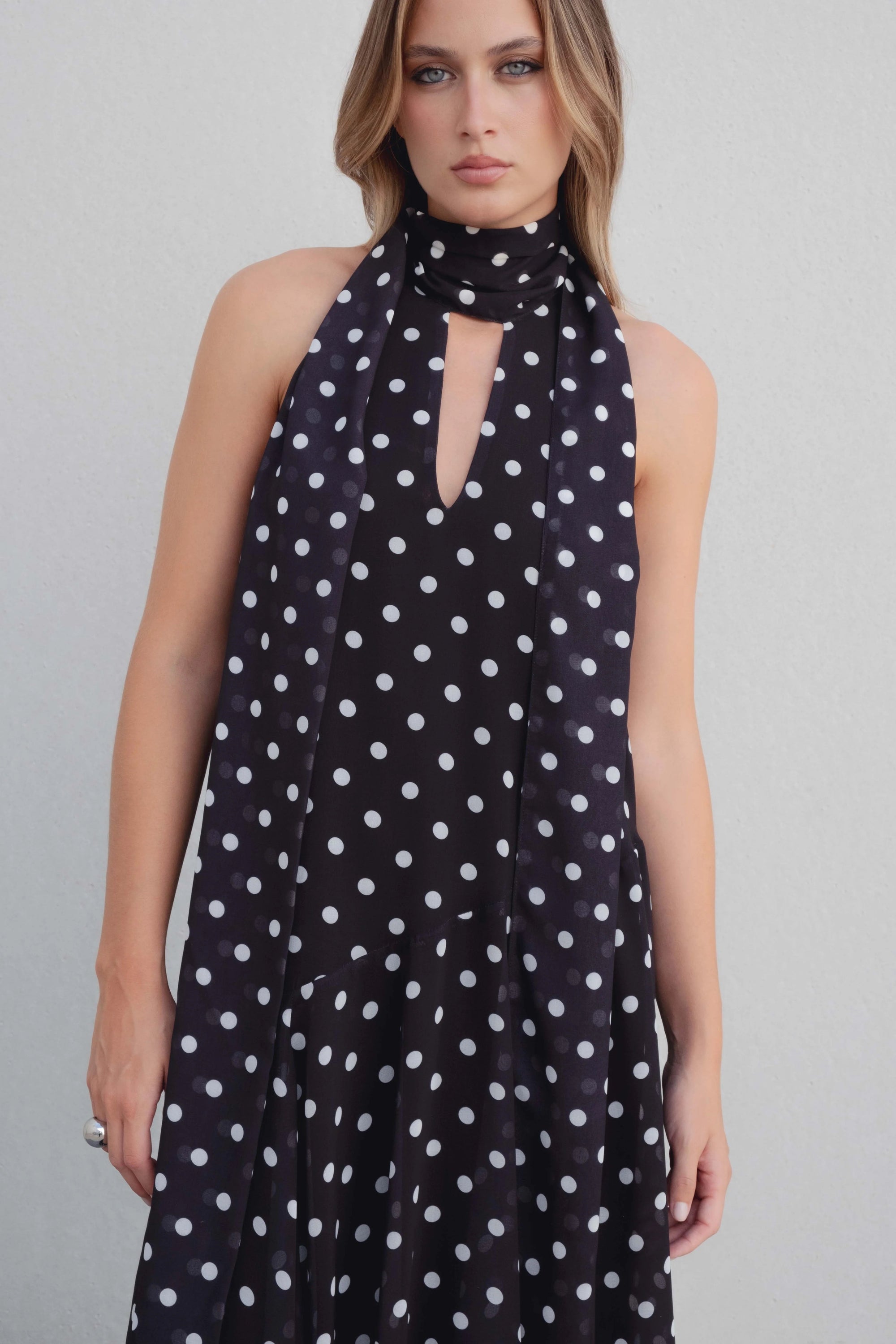 Robe noire à pois blancs fluide – col noué et coupe asymétrique Sapiato