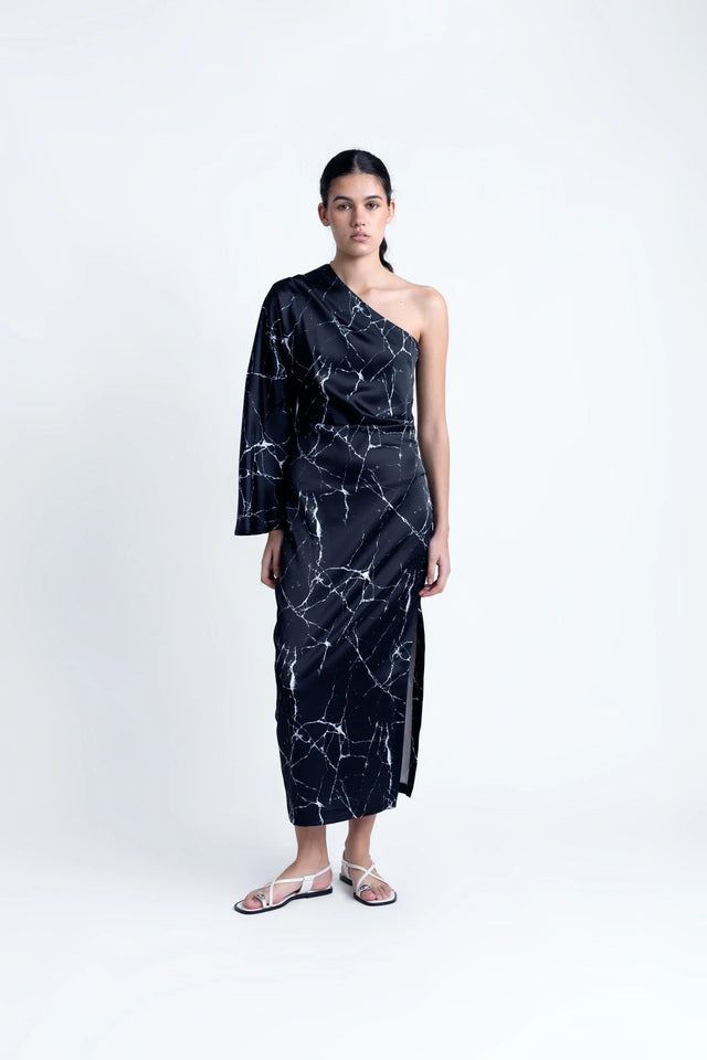 Modèle portant la Robe de Soirée Femme Asymétrique Satinée Noire Avec Imprimé Marbre, affichant un style chic avec une seule manche.