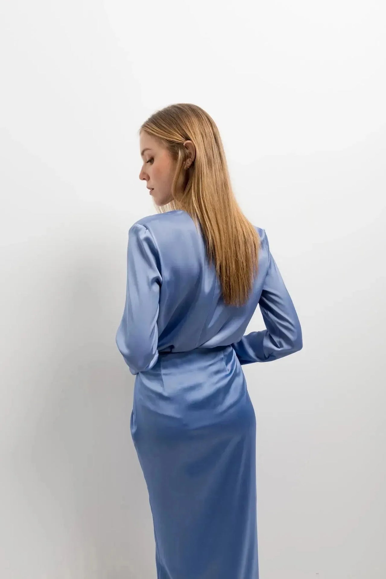 Femme portant une robe longue en satin bleu pervenche dans la chemise en satin