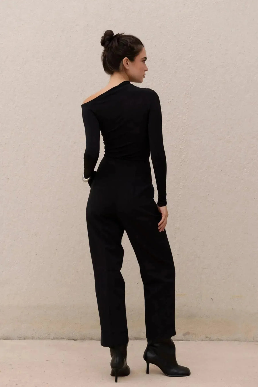 T-shirt asymétrique noir à manches longues avec pantalon large pour un look moderne